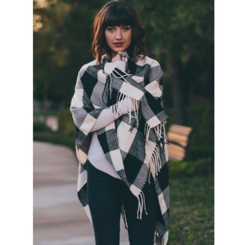 Black and white plaid poncho with fringe.
